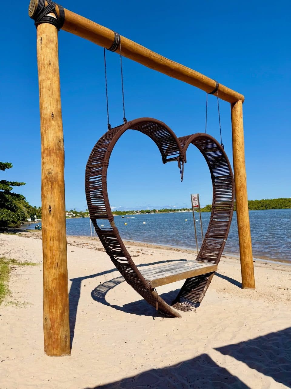 Wooden heart frame on the beach
