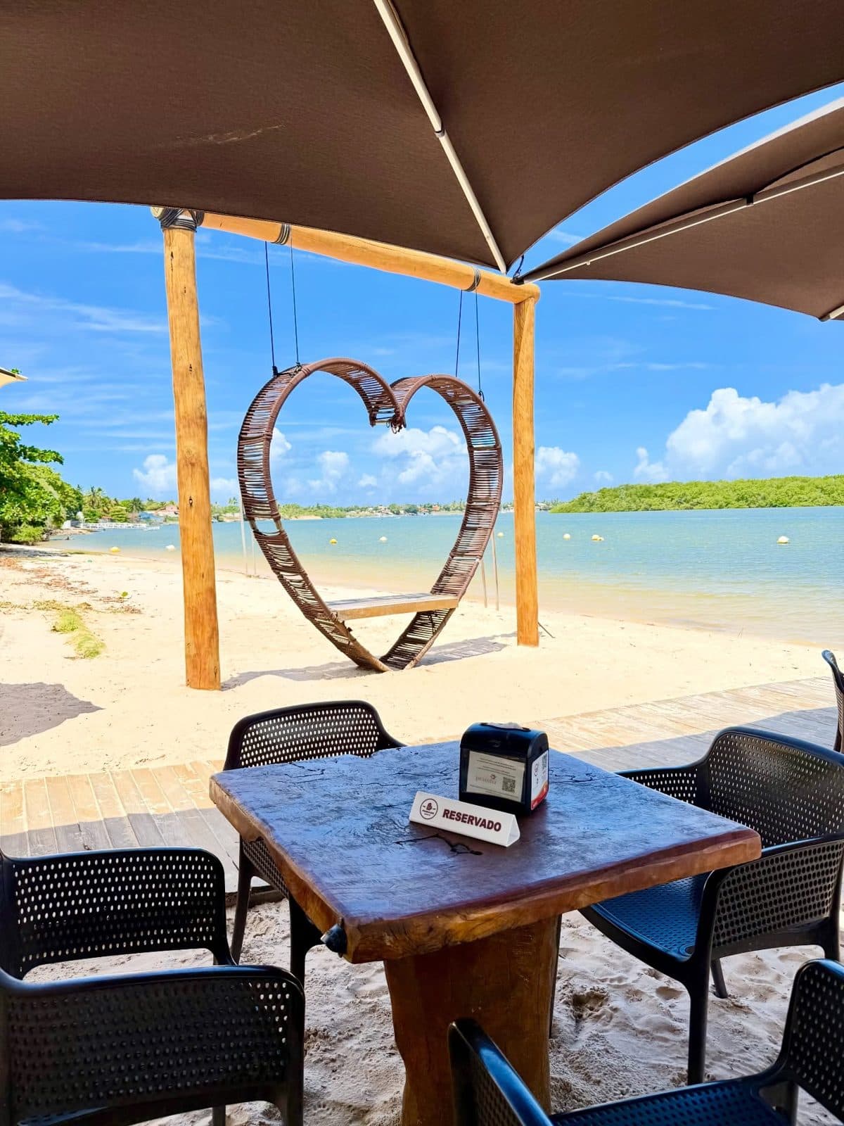 Wooden heart on the sand